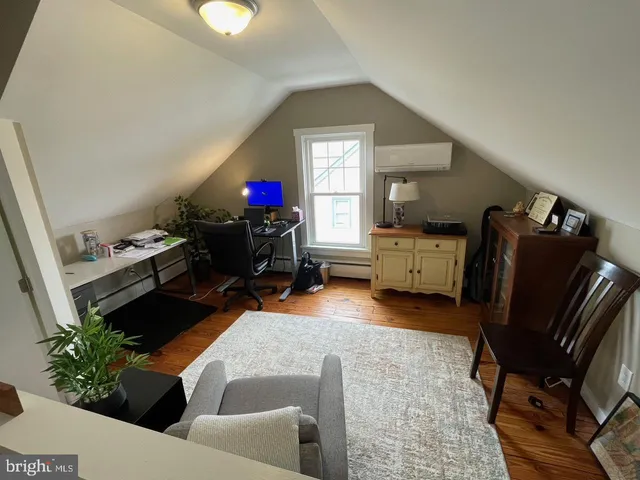 a living room with furniture and a mirror