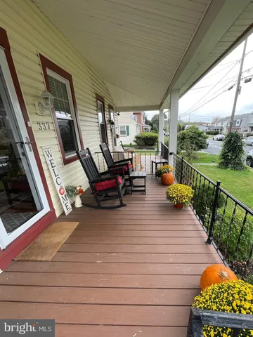 a view of a deck with wooden floor and outdoor seating