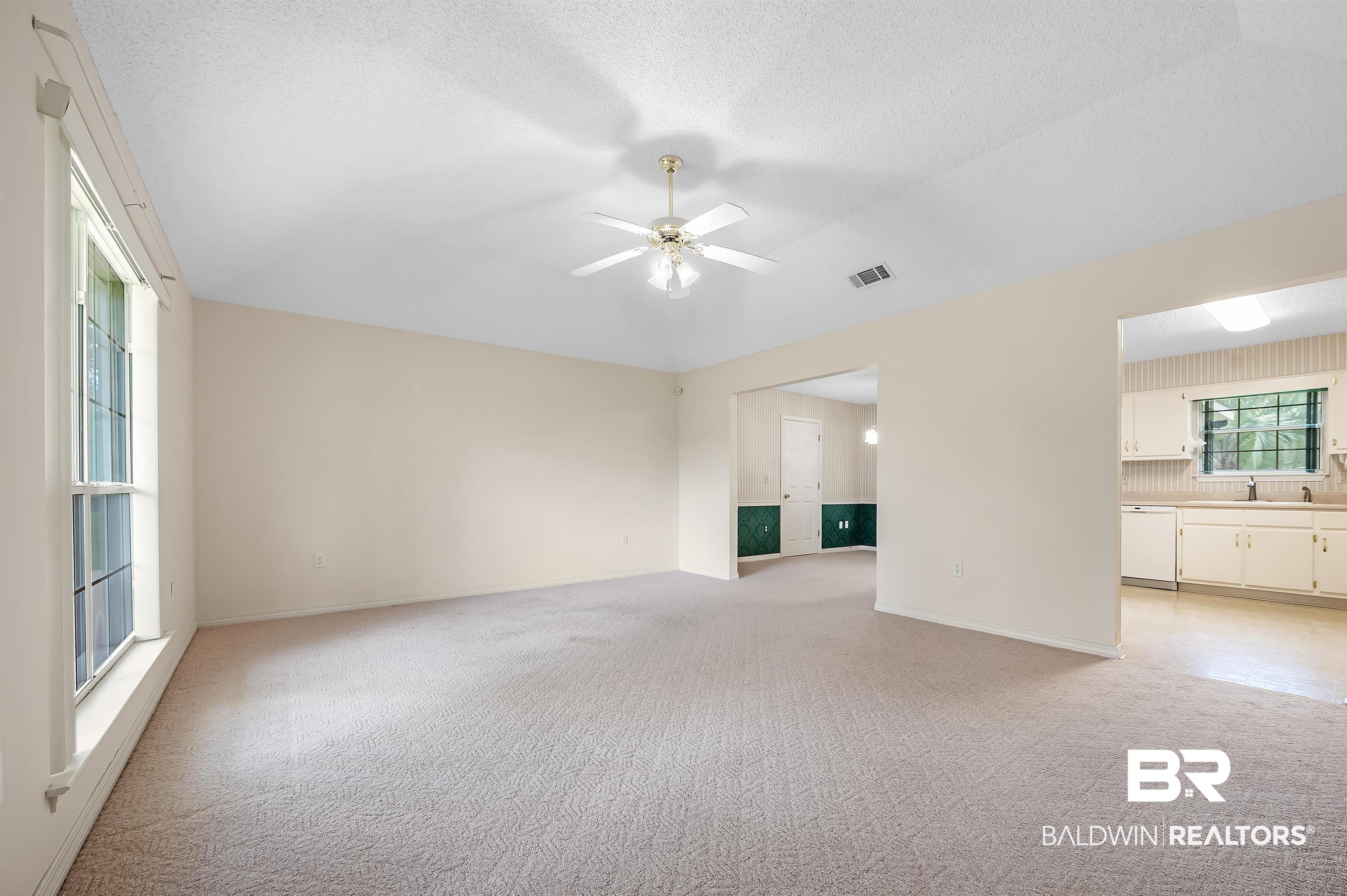 1502 Mulberry Lane Foley, AL 36535 - Photo 8 of 45 Livingroom featuring light carpet, a textured ceiling, , and ceiling fan