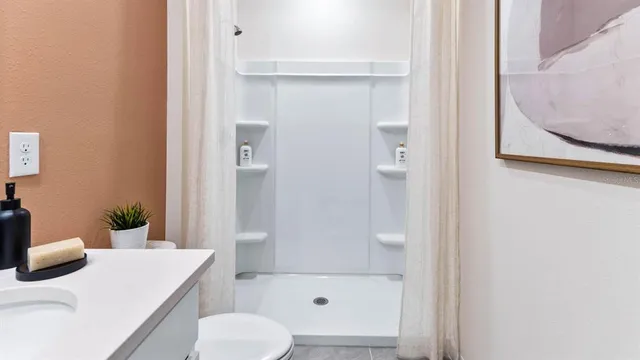 a bathroom with a sink toilet and shower