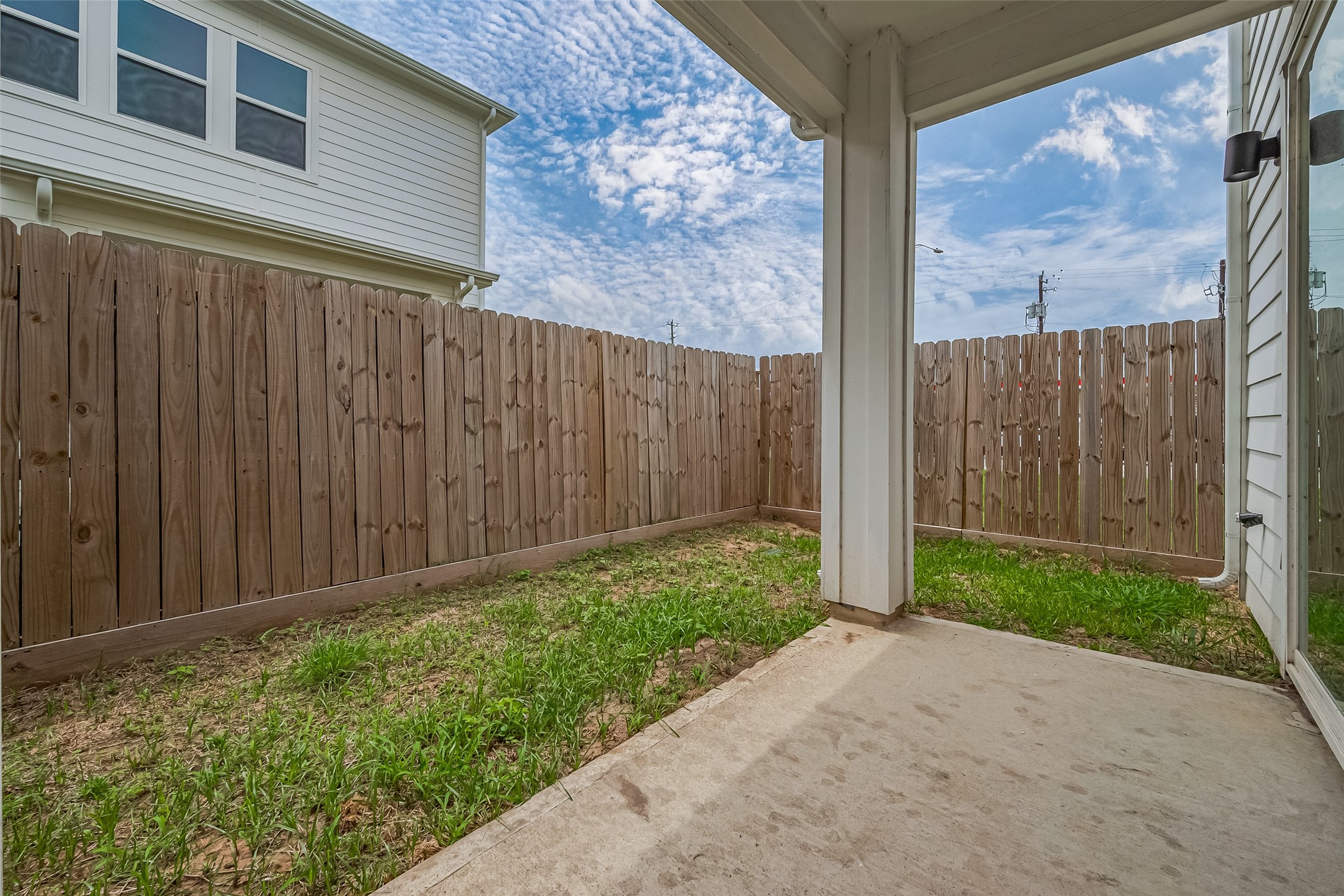 3510 Hadley Street Houston, TX 77004 - Photo 46 of 48 The covered patio extends the living space outdoors, with enough room for seating. It overlooks a grassy backyard, offering a private setting for relaxing or entertaining.