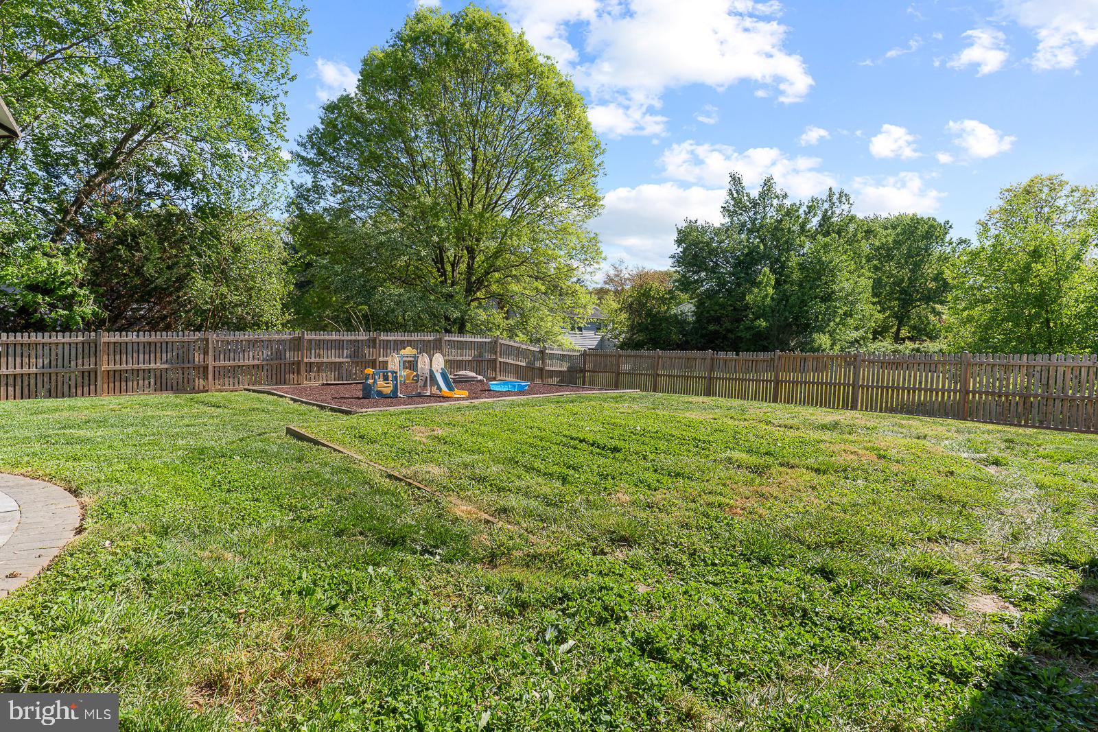 12229 Shadetree Lane Laurel, MD 20708 - Photo 33 of 36 Spacious backyard with lush greenery.