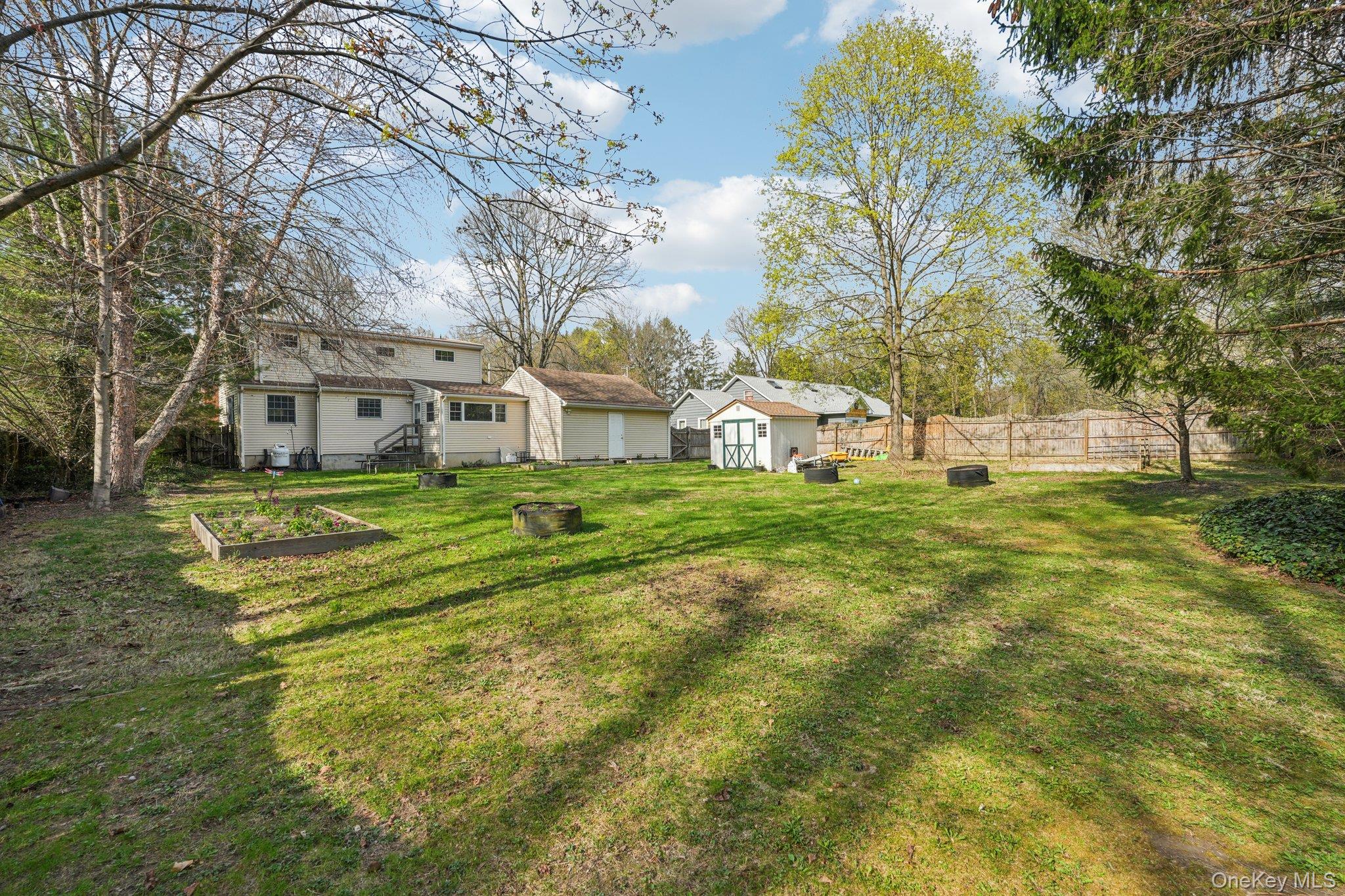 40 Widmer Road Wappingers Falls, NY 12590 - Photo 36 of 44 Fully fenced backyard with storage shed