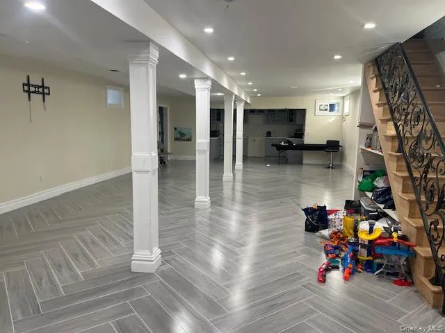 a hallway view with fireplace and wooden floor