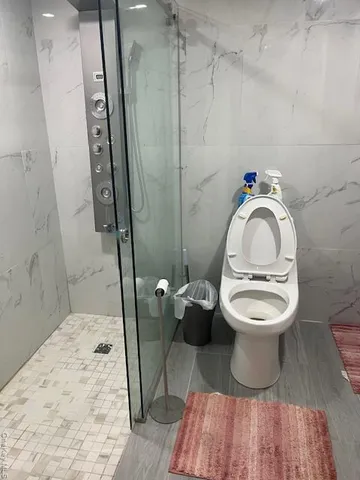 a bathroom with a toilet sink and shower