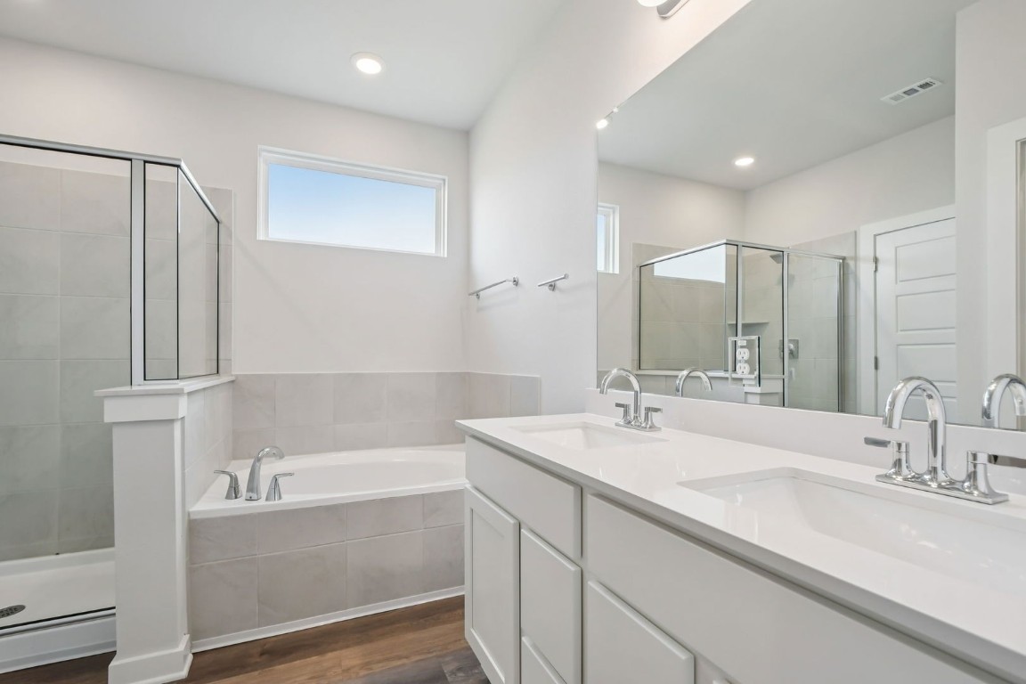 13419 Derby Ride Drive Buda, TX 78610 - Photo 13 of 29 a bathroom with a tub sink and mirror
