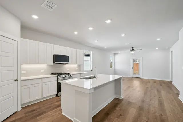 a kitchen with a sink stove and refrigerator