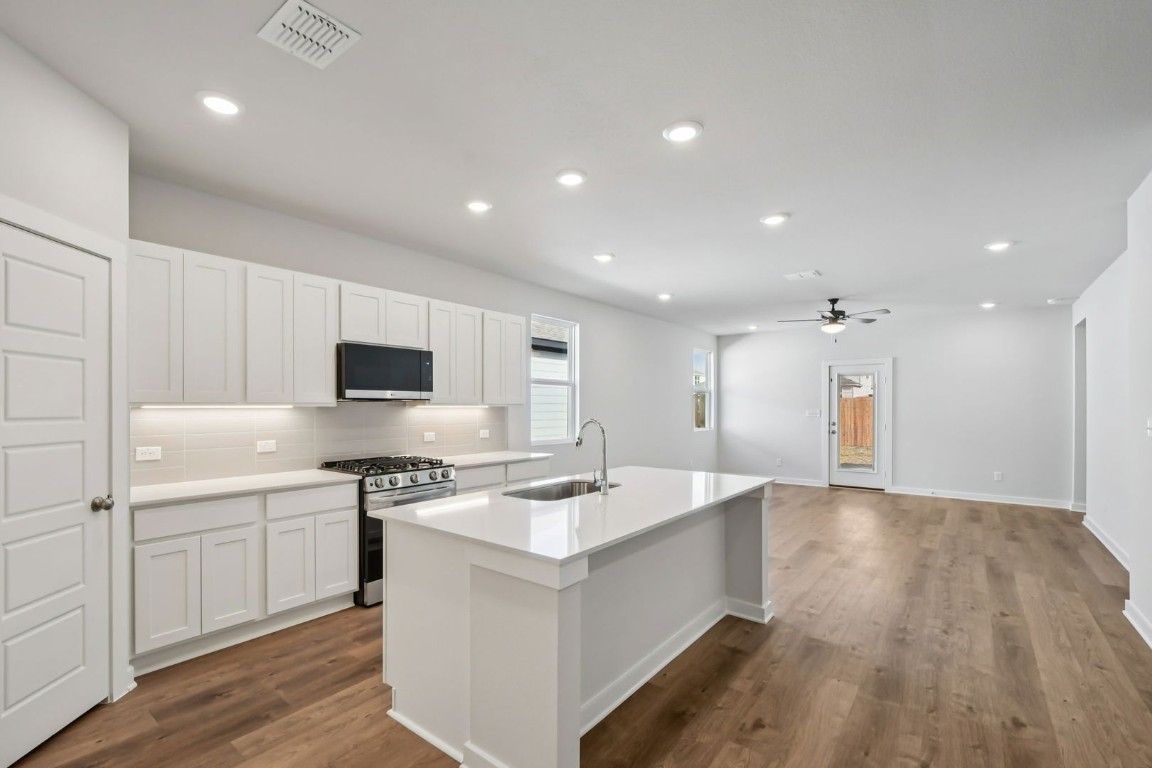 13419 Derby Ride Drive Buda, TX 78610 - Photo 2 of 29 a kitchen with a sink stove and refrigerator