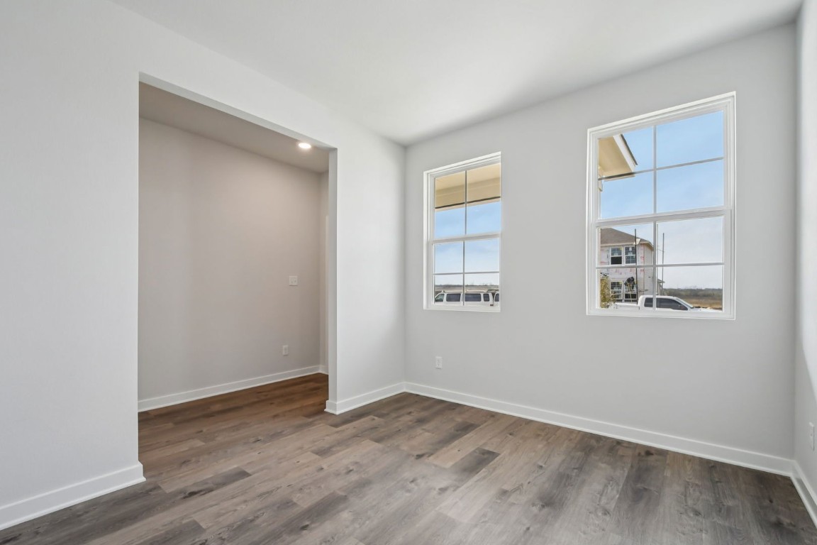 13419 Derby Ride Drive Buda, TX 78610 - Photo 21 of 29 an empty room with wooden floor and window
