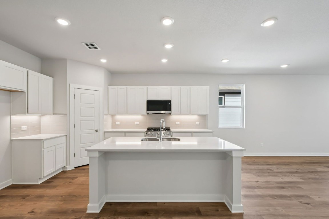13419 Derby Ride Drive Buda, TX 78610 - Photo 3 of 29 a view of kitchen with sink microwave and refrigerator