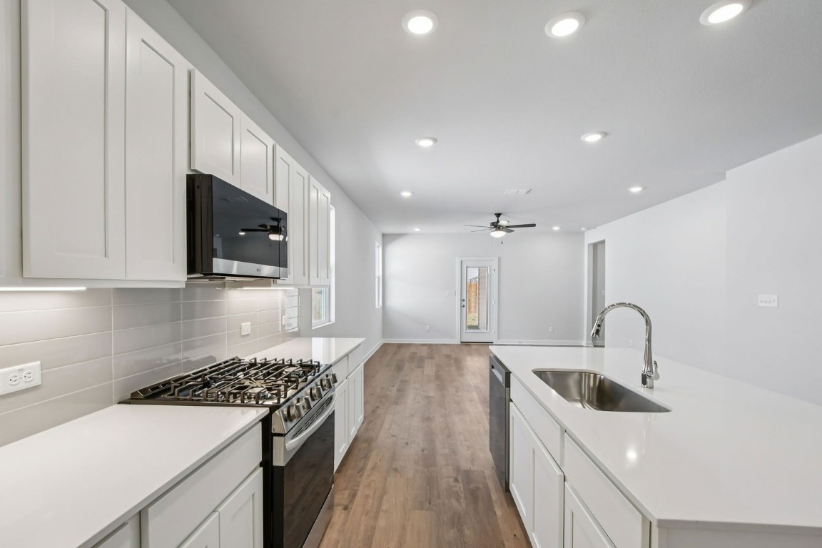 13419 Derby Ride Drive Buda, TX 78610 - Photo 5 of 29 a kitchen with a sink stove top oven and cabinets