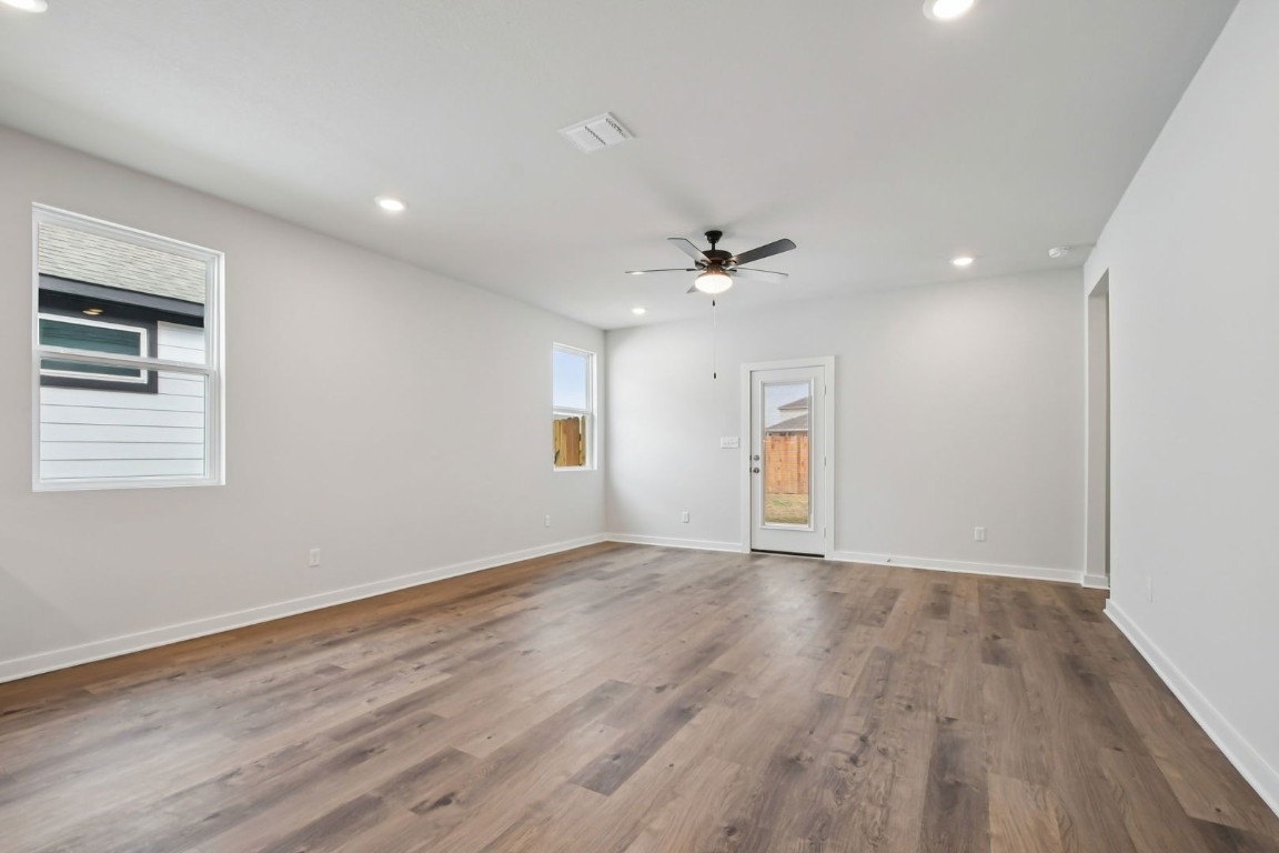 13419 Derby Ride Drive Buda, TX 78610 - Photo 8 of 29 a view of an empty room with wooden floor