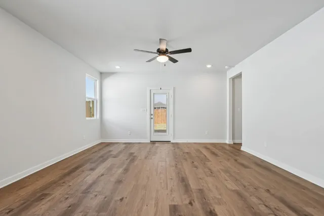 wooden floor in an empty room with a window