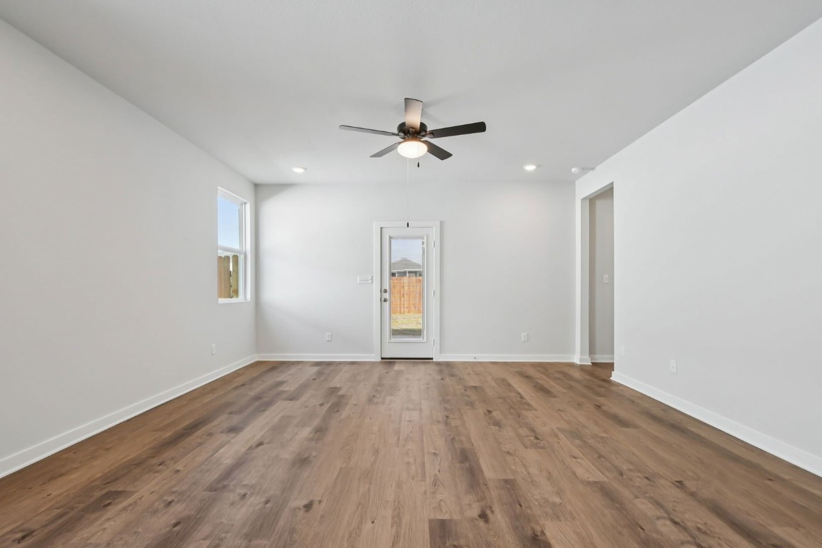 13419 Derby Ride Drive Buda, TX 78610 - Photo 9 of 29 wooden floor in an empty room with a window