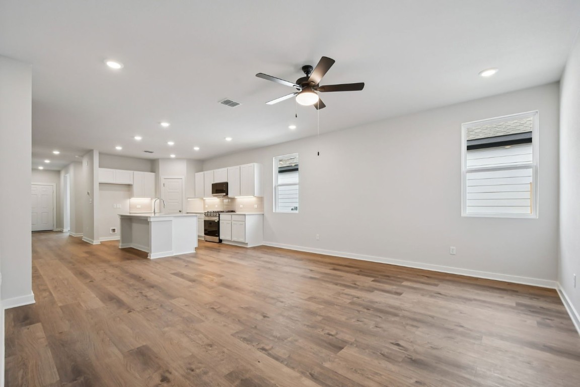 13419 Derby Ride Drive Buda, TX 78610 - Photo 10 of 29 a view of a livingroom with a ceiling fan a ceiling fan and kitchen view