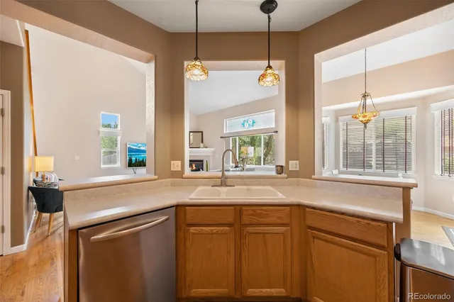 a kitchen with stainless steel appliances granite countertop a sink a stove a refrigerator cabinets and a kitchen island