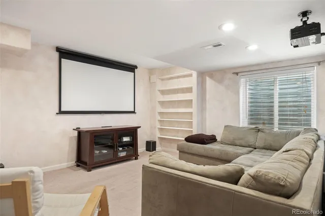 a bathroom with a granite countertop sink a mirror and shower