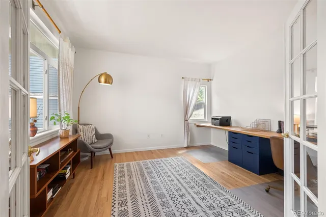 a bedroom with a large bed and a flat tv screen on dresser