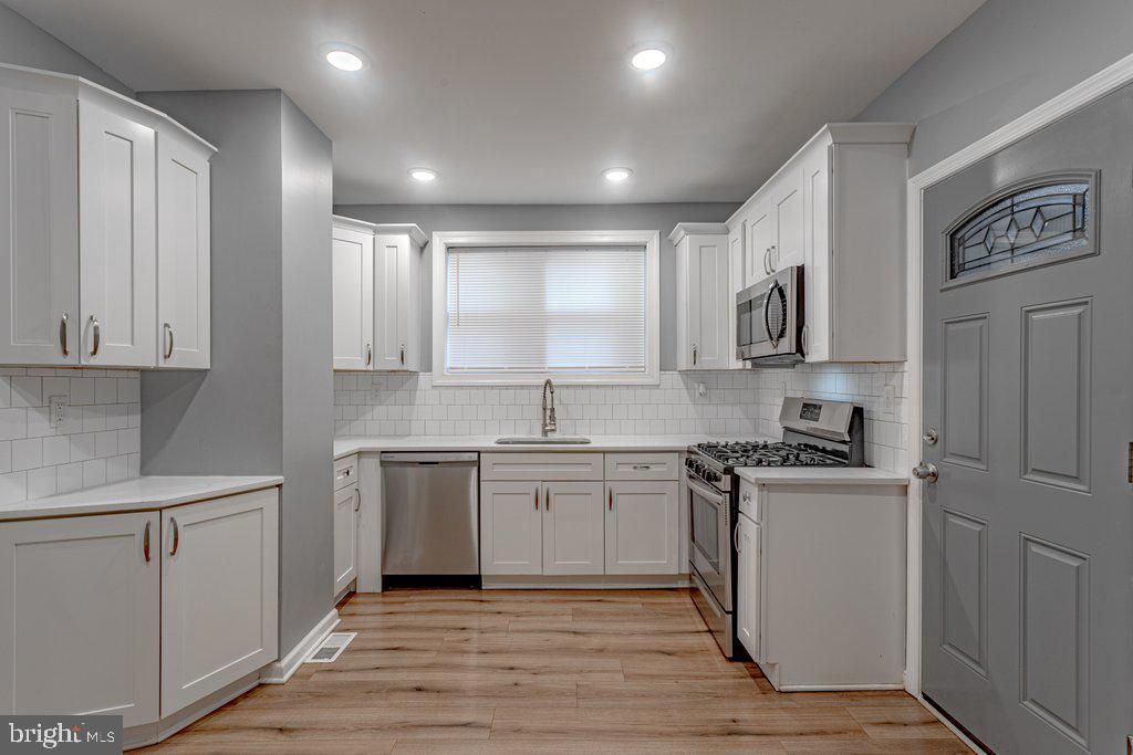 215 North Fairview Street Riverside, NJ 08075 - Photo 11 of 25 a kitchen with kitchen island granite countertop appliances cabinets and a sink