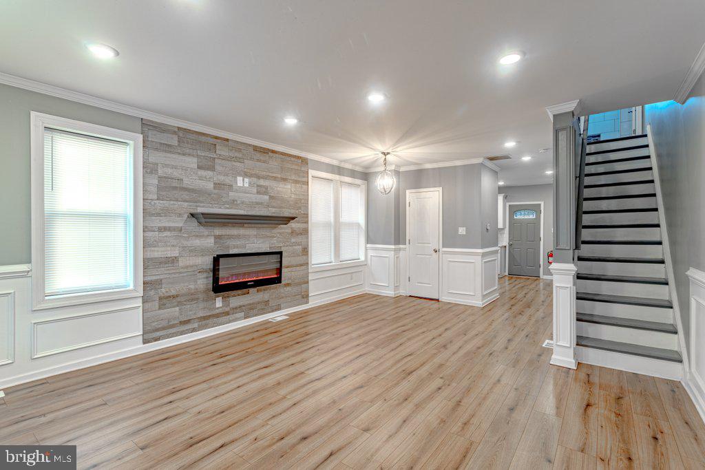 215 North Fairview Street Riverside, NJ 08075 - Photo 16 of 25 an empty room with wooden floor fireplace and windows