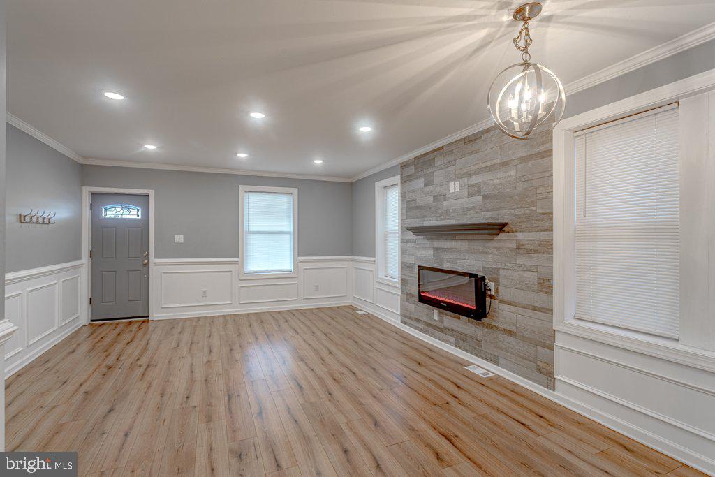 215 North Fairview Street Riverside, NJ 08075 - Photo 2 of 25 a big room with wooden floor fireplace cabinet and windows
