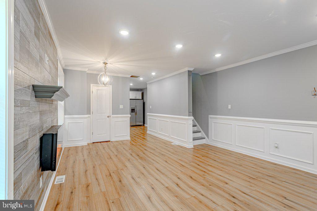 215 North Fairview Street Riverside, NJ 08075 - Photo 3 of 25 a view of empty room with wooden floor and fireplace