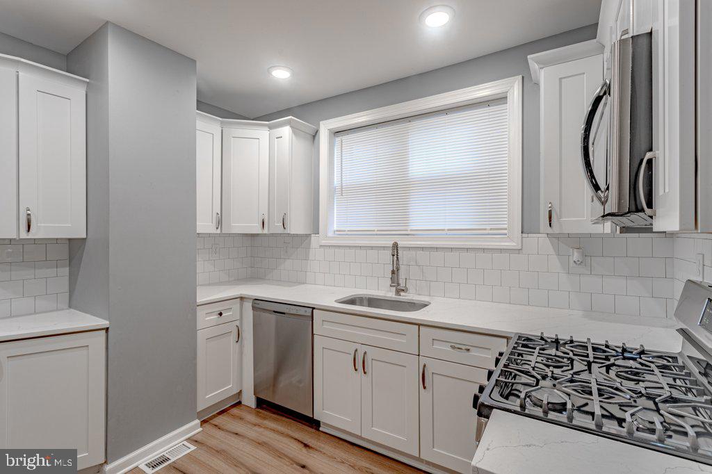 215 North Fairview Street Riverside, NJ 08075 - Photo 10 of 25 a kitchen with a sink stove and cabinets