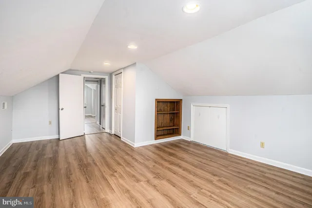a view of an empty room with wooden floor
