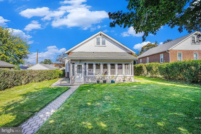 a view of a house with a yard and porch