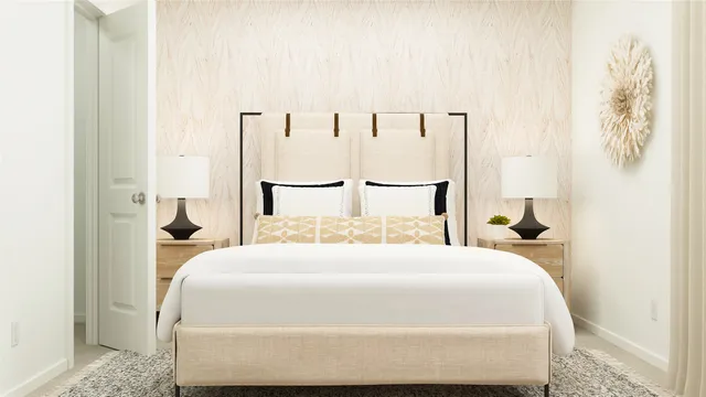 a bedroom with a large bed and paintings on the wall