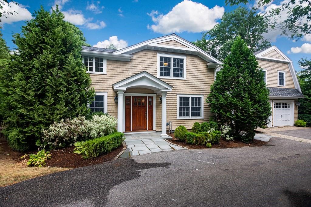 a front view of a house with a garden