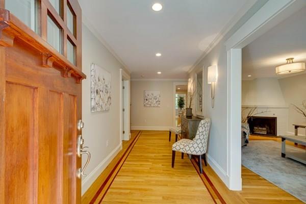 24 Birch Road Wellesley, MA 02482 - Photo 11 of 39 a hallway with a couch and a dining table next to a window
