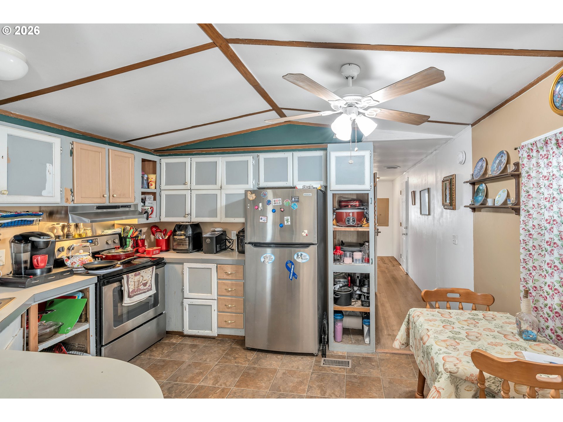 10038 South New Era Road, Unit 25 Canby, OR 97013 - Photo 12 of 39 a kitchen with stainless steel appliances kitchen island granite countertop a refrigerator oven a sink and dishwasher