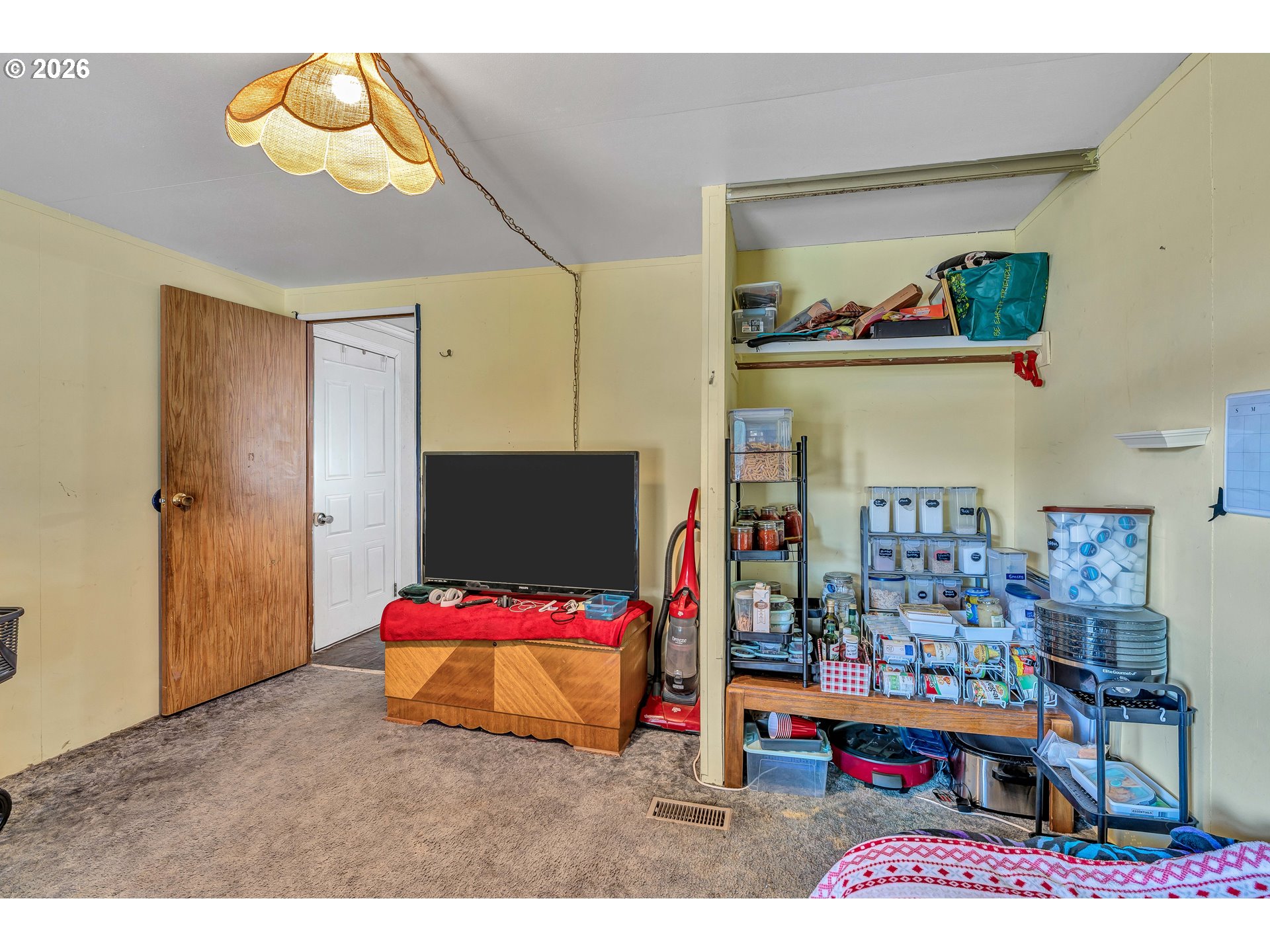 10038 South New Era Road, Unit 25 Canby, OR 97013 - Photo 16 of 39 a bedroom with a bed and a chandelier