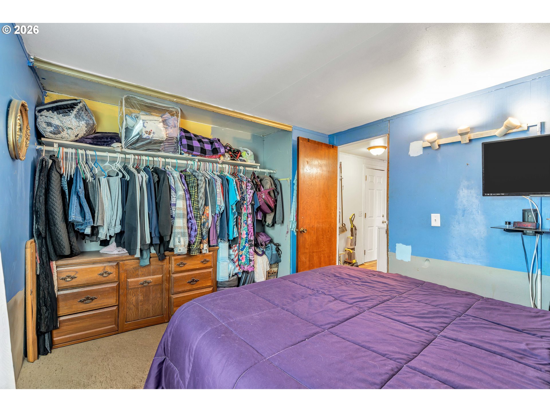 10038 South New Era Road, Unit 25 Canby, OR 97013 - Photo 23 of 39 a bedroom with a bed and a flat tv screen on dresser