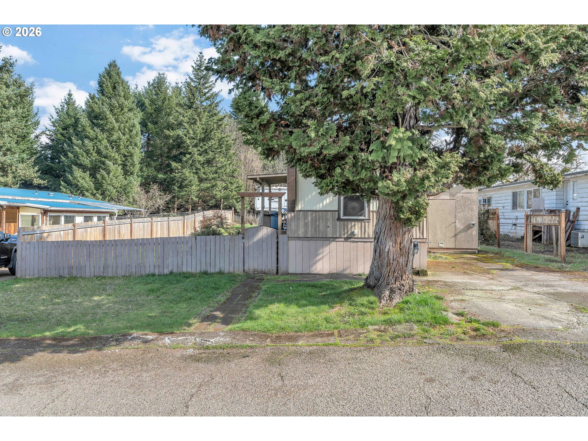 10038 South New Era Road, Unit 25 Canby, OR 97013 - Photo 3 of 39 a view of a backyard with a tree