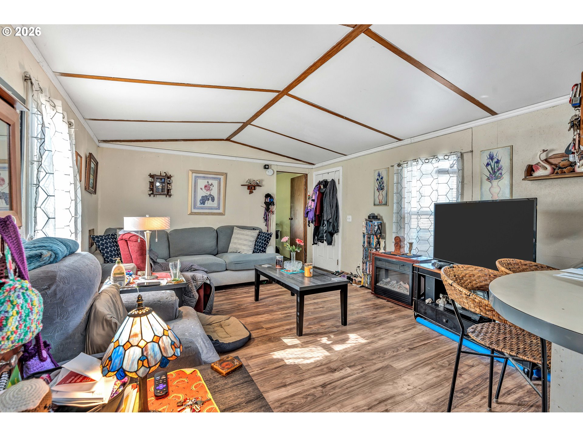 10038 South New Era Road, Unit 25 Canby, OR 97013 - Photo 9 of 39 a living room with furniture and a flat screen tv