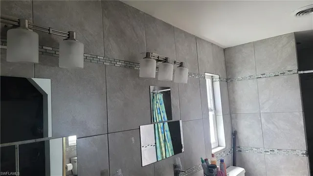 a bathroom with a shower and a mirror