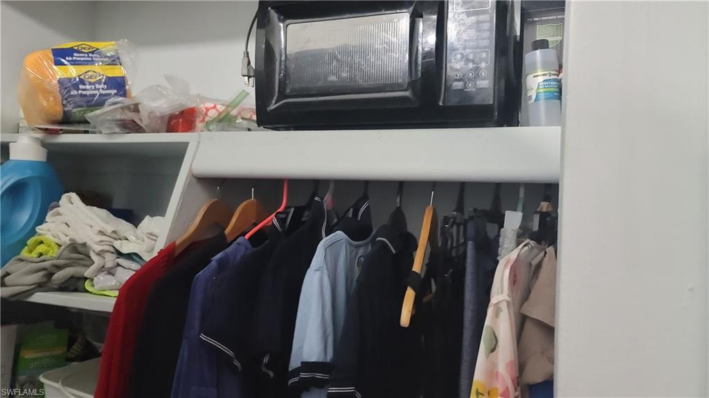 2172 45th Street Southwest Naples, FL 34116 - Photo 21 of 26 a view of walk in closet with clothes and shoes