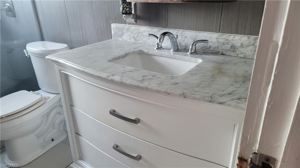 2172 45th Street Southwest Naples, FL 34116 - Photo 23 of 26 a bathroom with a sink and toilet