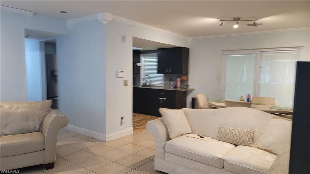 2172 45th Street Southwest Naples, FL 34116 - Photo 5 of 26 a living room with a couch and a flat screen tv