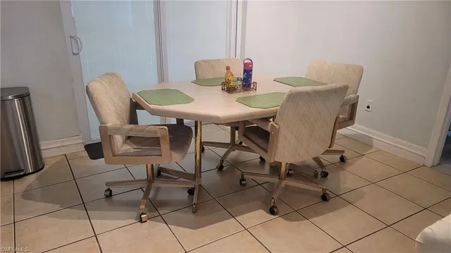a view of a dining room with tables and chairs