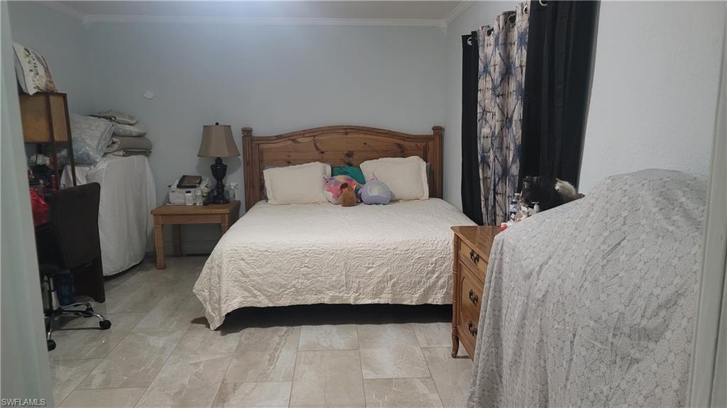 2172 45th Street Southwest Naples, FL 34116 - Photo 9 of 26 a bedroom with a bed and a window