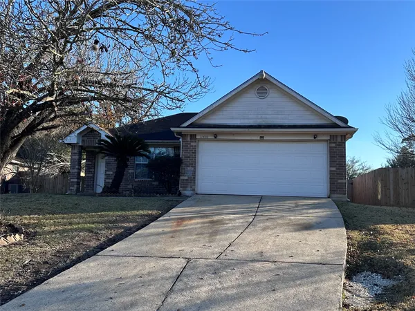 a front view of a house with yard and trees
