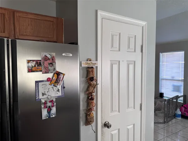 a kitchen with stainless steel appliances granite countertop a stove top oven a sink dishwasher and a refrigerator