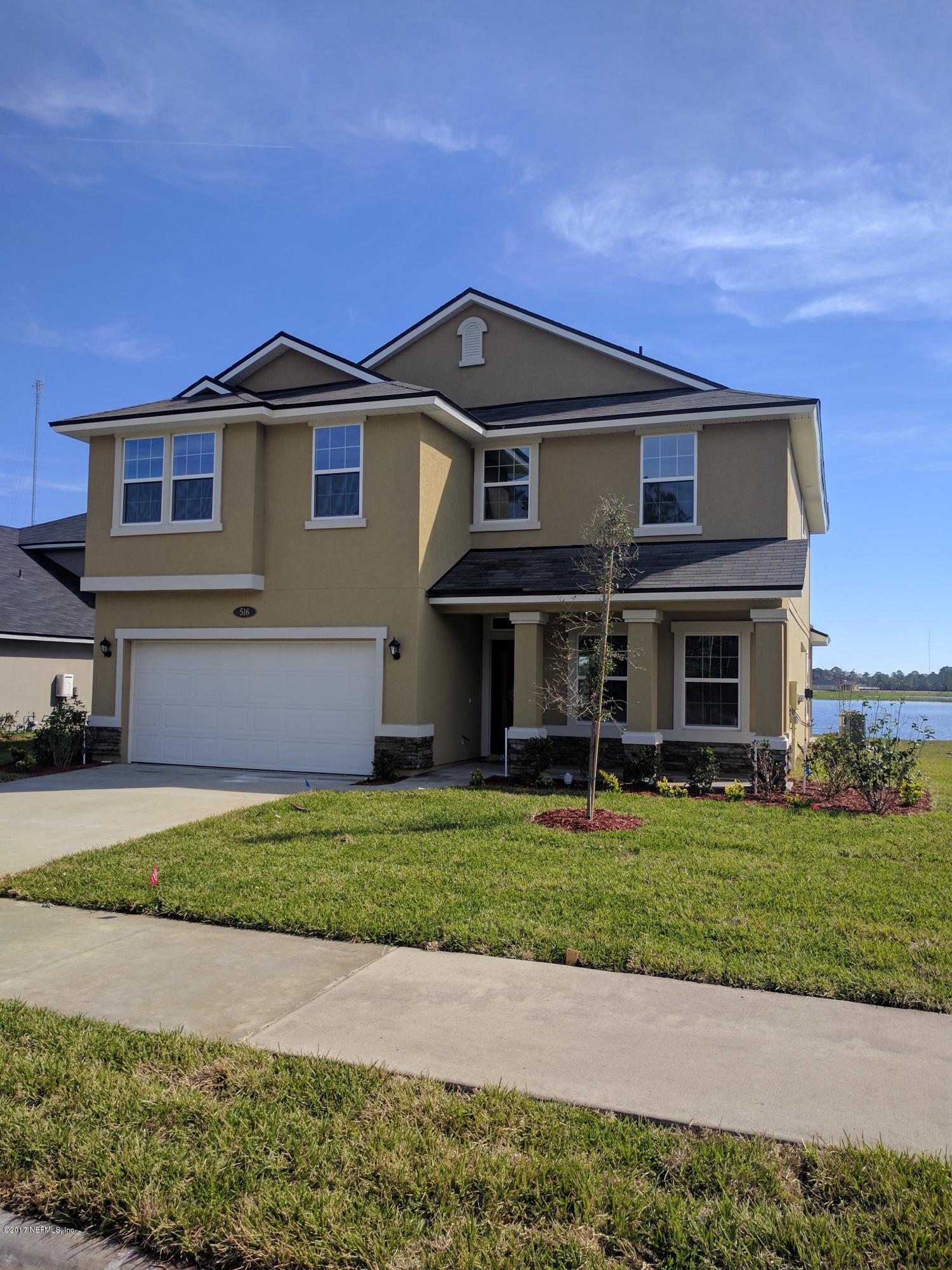 516 Deer Crossing Road St. Augustine, FL 32086 - Photo 1 of 43 a front view of a house with a garden and yard