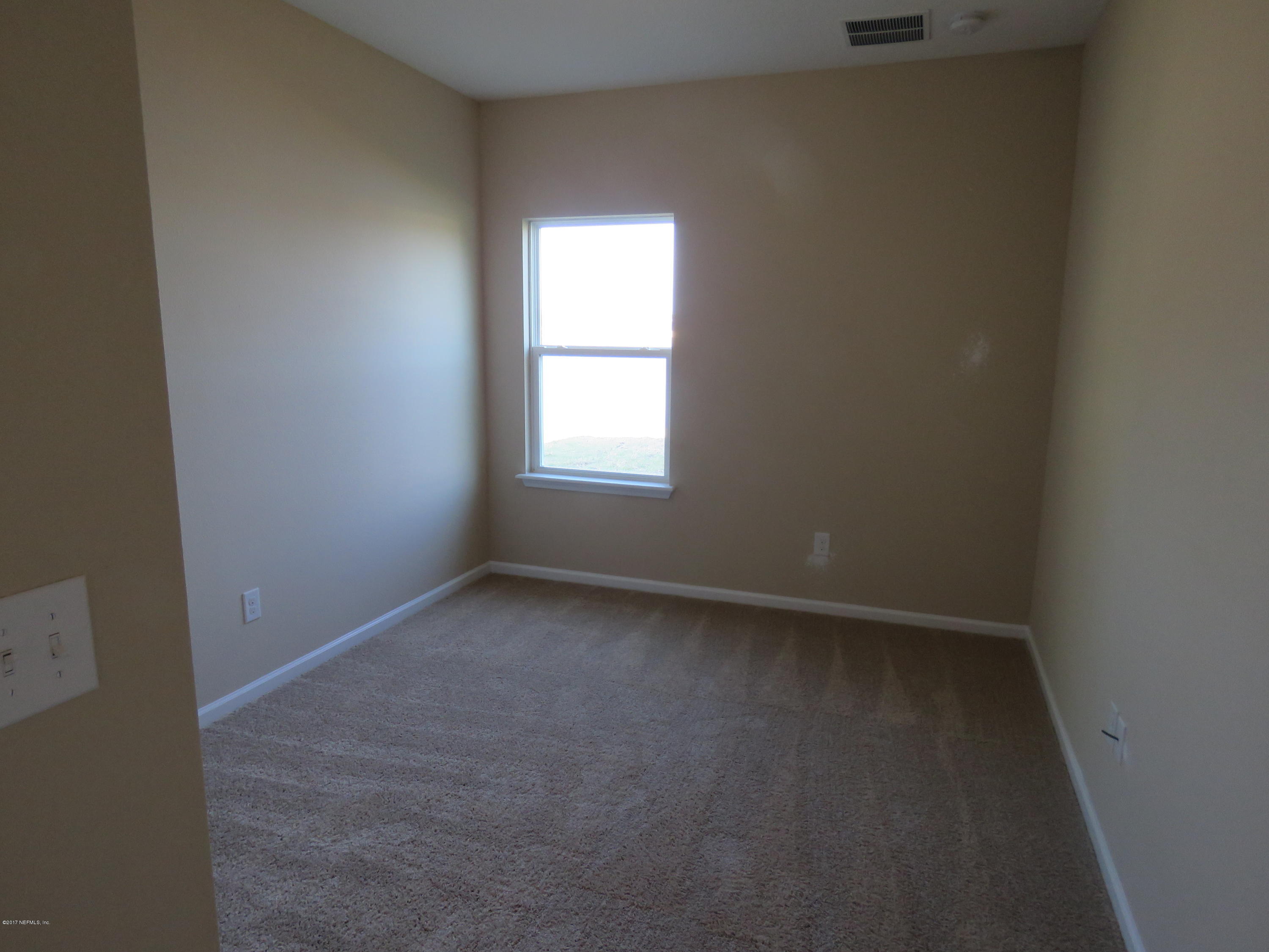 516 Deer Crossing Road St. Augustine, FL 32086 - Photo 27 of 43 an empty room with a window