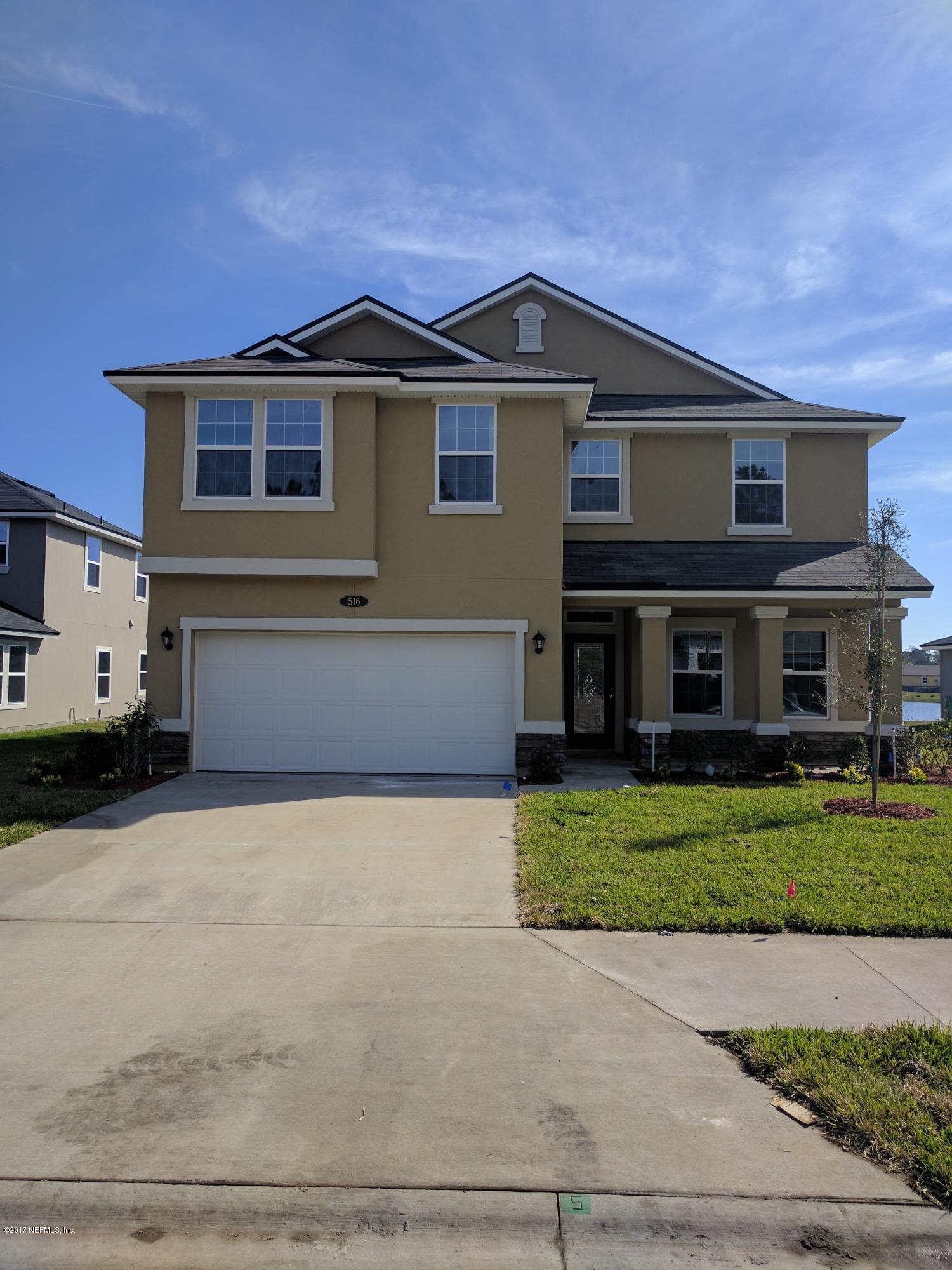 516 Deer Crossing Road St. Augustine, FL 32086 - Photo 2 of 43 a front view of a house with a garden and pathway