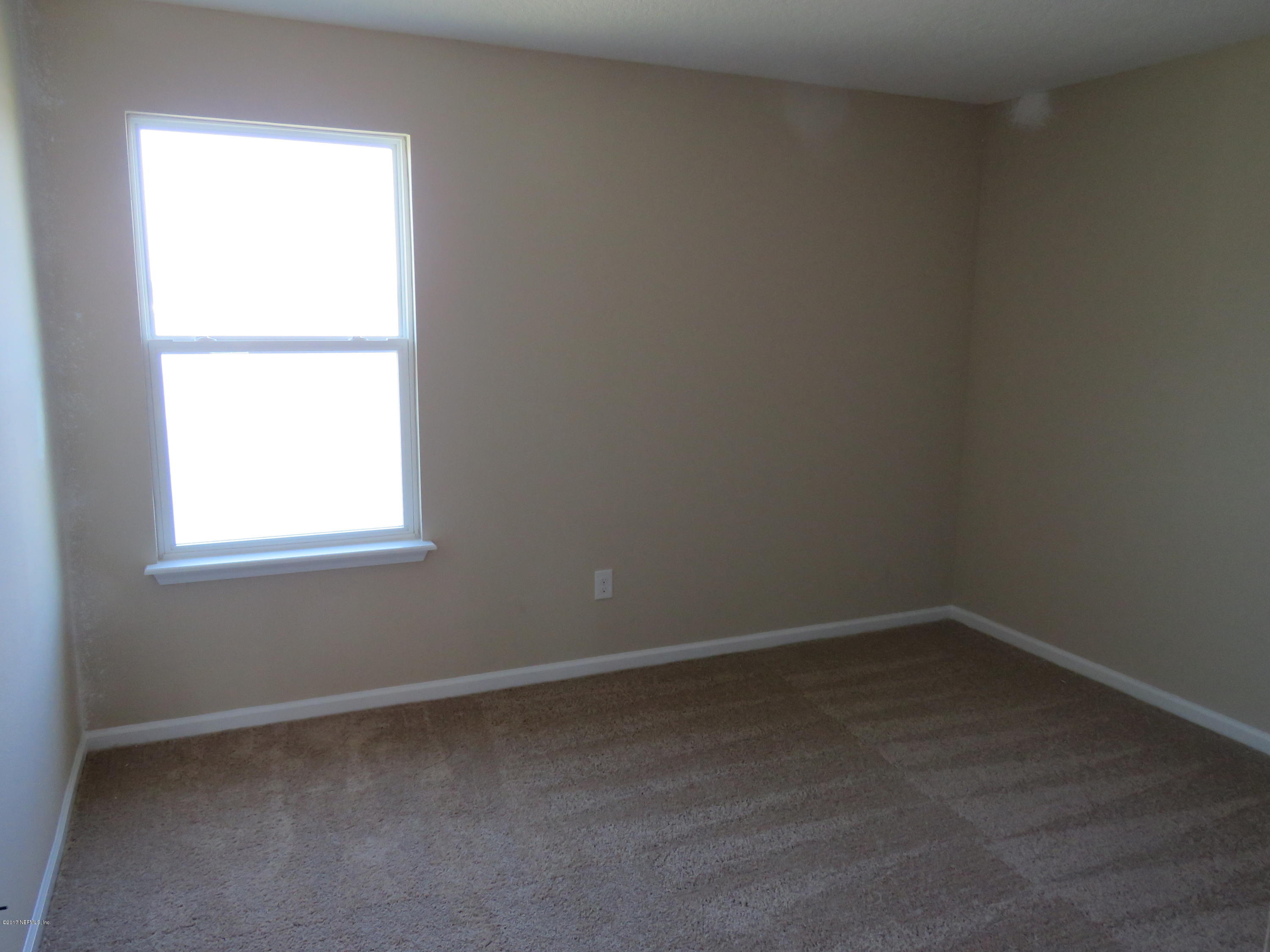 516 Deer Crossing Road St. Augustine, FL 32086 - Photo 31 of 43 an empty room with a window