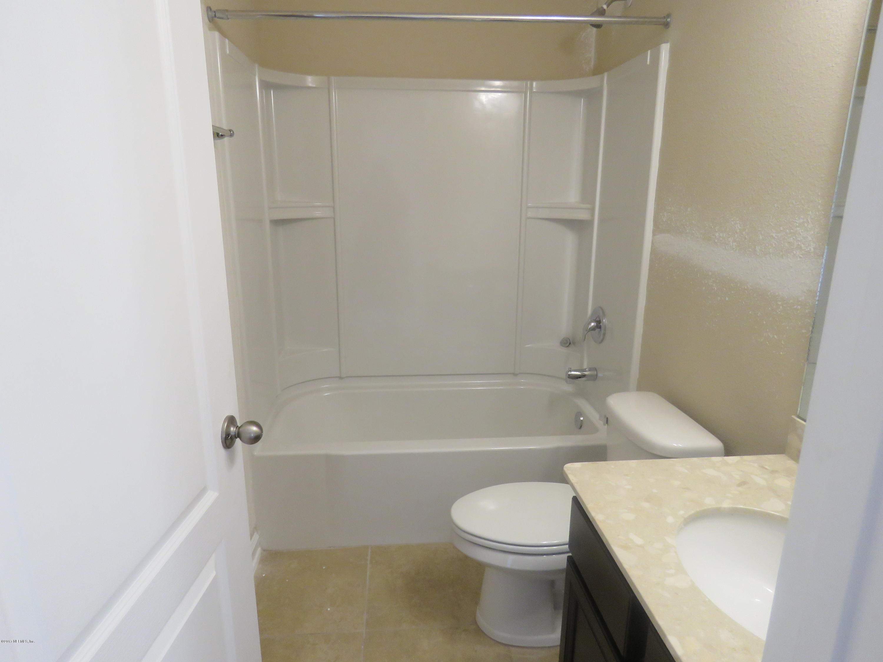 516 Deer Crossing Road St. Augustine, FL 32086 - Photo 34 of 43 a bathroom with a toilet and a bath tub